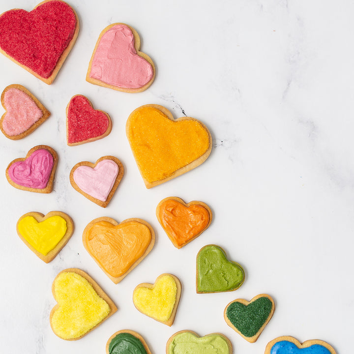 Rainbow heart sugar cookies decorated with natural food colors and dye free sanding sugars.